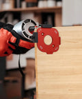 Heavy Duty Aluminum Router Corner Radius Template Kit Including Eight Radius Measurement Options For Butter Smooth Woodworking Edge Profiling And Router Table Jig Setup That Guarantees Zero Headaches. Red jig attached to wood edge with drill.