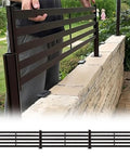 Heavy Duty Aluminum Fence Height Extender For Low Walls Featuring Anti Climb Design and Weather Ready Build shown being installed on a low wall.