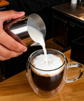 Pouring milk into Six Pack Double Wall Insulated Espresso Cups With Handles Clear Borosilicate Glass Shot Glasses Heat Resistant