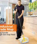 No Sweat Heavy Duty Commercial Mop Bucket On Wheels With Side Press Wringer And 35 Quart Size For Knocking Out Floor Cleanup Fast At Hotel Or Bank Sites Today being used by a janitor in a modern lobby.