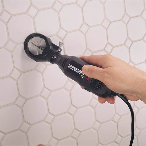 Grout Removal Rotary Tool Attachment For Tile Grout Lines With A 30 Degree Cutting Angle Centered Guides Large Visibility Window And Depth Adjustment To Three Eighths Inch For Wall And Floor Grout By Dremel in use on wall tiles