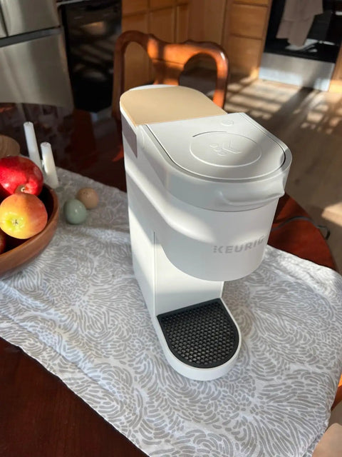 K Mini Coffee Maker on table with Replacement Drip Tray Cover For K Mini Coffee Makers Durable ABS Plastic Easy Clean Surface No Fuss Snug Fit Snap On Installation Keeps Brewer Clean Black Color Only Tray Cover visible.