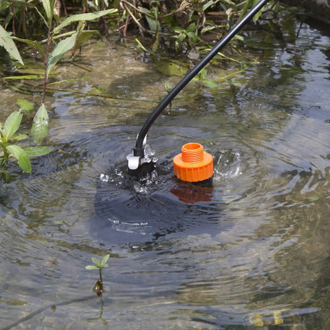 Submersible Water Pump One Third HP 2500GPH Portable Electric Utility Pump in use for water drainage in pond.