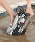 Person using 1 HP Submersible Sump Pump With 5500 GPH Flow Stainless Steel Build Automatic Float Switch Long Cord 30 Ft Lift in muddy water