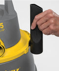 Hand attaching accessory to Contractor Wet Dry Vacuum Cleaner For Jobsites And Shops With 9.0 Gallon Tank 1200 Watt Power 7 Foot Hose