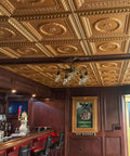 Bar interior with detailed tin-look ceiling tiles above, showcasing the Laurel Wreath Faux Tin Ceiling Tiles White Pearl 25 Pack No Fuss Install Easy Glue Up Or Drop In Grid System DIY Friendly Makeover For A Sleek Classic Tin Look In Any Room.