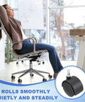 Person sitting on an office chair with 8 Pack 2 Inch Nylon Office Chair Wheels Replacement Heavy Duty Casters highlighted, smooth rolling on hardwood floor.