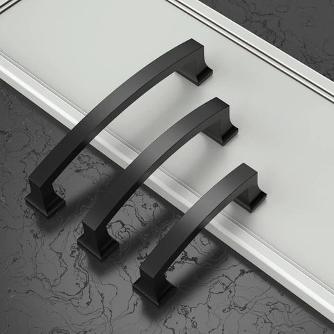 Three oil rubbed bronze cabinet handles on black marble, each with 4 inch hole centers, part of the 30 pack kitchen cabinet pulls set.