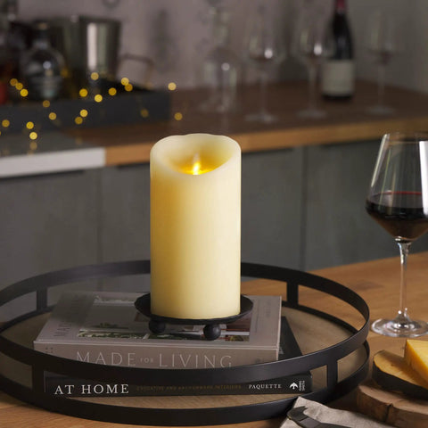 Ivory Flameless LED Pillar Candle With Moving Flame on a table in a cozy setting, 4 Inch by 7 Inch, real wax, scalloped edge.