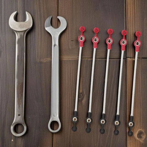 Five Pack Battery Tricycle Charging Cable Connector For EVs, wrenches and cables displayed on wooden surface