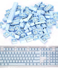 Premium PBT Keycaps With Dope Colorway And Ergonomic Arc Fit Smooth Typing Feel Hella Durable Oil Resistant Texture Perfect 108 Keys Layout For Gaming Rigs And Productivity Workstations In Light Blue Finish arranged on a clear keyboard.
