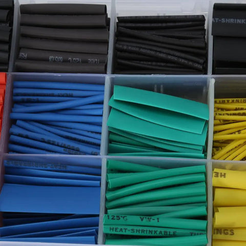 Close-up of 530-piece heat shrink tubing kit with 1.5 to 10mm tubes in black, red, yellow, blue, green; garage-ready, halogen-free.