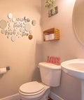 30 Piece Bathroom Wall Decals Set With 3D Round Mirror Stickers in a bathroom above toilet and sink.