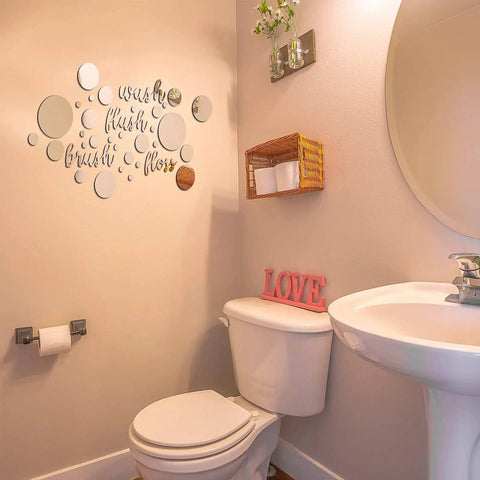 30 Piece Bathroom Wall Decals Set With 3D Round Mirror Stickers in a bathroom above toilet and sink.
