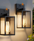 Two Pack Automatic Dusk To Dawn Exterior Wall Lights With Smart Photo Sensor Waterproof Black Coach Porch Fixture, showing warm light with glass enclosure.