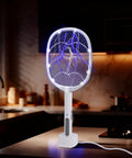 3 Pack Electric Fly Swatter Rackets For Home And Outdoor Use on kitchen counter, showing blue electric charge and safety switch.