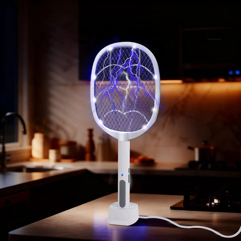 3 Pack Electric Fly Swatter Rackets For Home And Outdoor Use on kitchen counter, showing blue electric charge and safety switch.