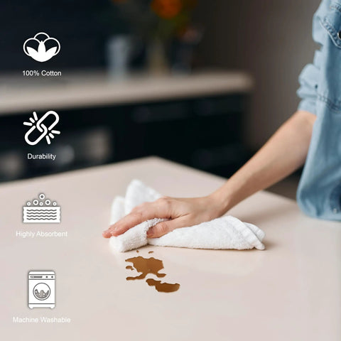 Person using Pack Of 50 White 12 By 12 Inch Cotton Terry Cleaning Cloths For Auto Detailing, Painters, And General Cleaning on countertop