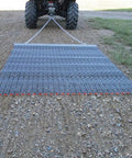 Ultra Heavy Duty ATV UTV Field Surface Leveling Drag Mat with zinc and steel build in use, showing galvanized mesh for yard work.