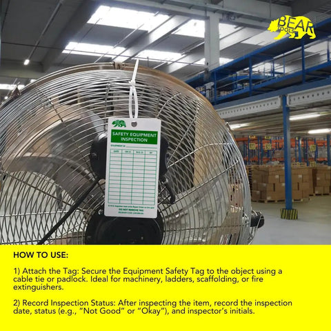 Safety Equipment Inspection Notice for Hazard and Accident Prevention Tags attached to a large industrial fan in warehouse