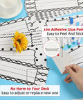 64 Piece Black And White Scribble Classroom Name Plates Set with 200 adhesive points, easy to peel and stick, shown on desk.