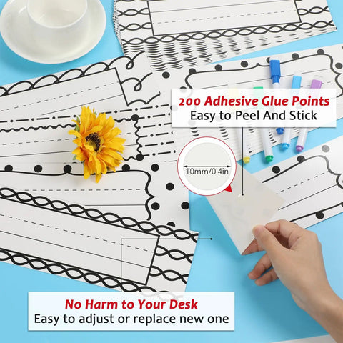 64 Piece Black And White Scribble Classroom Name Plates Set with 200 adhesive points, easy to peel and stick, shown on desk.