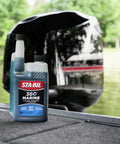 Marine Fuel System Treatment 32 Oz For Boats And Watercraft bottle on boat deck near engine, treats up to 320 gallons.