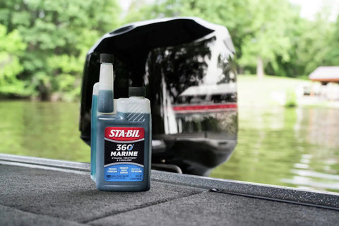 Marine Fuel System Treatment 32 Oz For Boats And Watercraft bottle on boat deck near engine, treats up to 320 gallons.