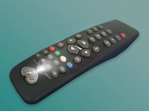 Ultra Compact Stick On LED Thumb Light attached to a TV remote, illuminating buttons with bright light