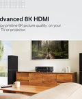 Living room setup with 7.2 Channel 8K HDR Home Theater Receiver With 75W Per Channel, Built In HEOS Wireless Streaming on cabinet.