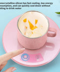 Electric Desk Cup Warmer And Cooler For Coffee Mugs Cans Bottles Precise Hot Cold Temp Control Keep Your Daily Brew Cozy Or Truly Ice Chill Home Office Game Changer Easy Wipe Surface on a pink platform with controls and a beverage.