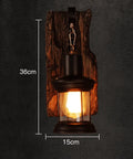 Top Shelf Rustic Wall Sconce Featuring Solid Wood Backplate And Vintage Industrial Metal Lantern Design Perfect For Chill Farmhouse Cafe Bar Or Bedroom Vibes Standard E26 E27 Socket Fits Up To Sixty Watt Bulbs, 36cm height, 15cm width.