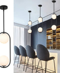 Modern Style Pendant Lighting With White Globe Glass Shade For Kitchen Island, Dining Room, And Bedroom, Mid Century Vintage Hanging Light Fixture, Adjustable Height Pendant Chandelier over modern dining area.