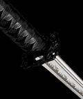 Close-up of Real Carbon Steel Katana for Iaido Practice and Display, Unsharpened Full Tang Samurai Sword hilt and blade engraving.