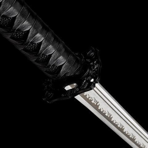 Close-up of Real Carbon Steel Katana for Iaido Practice and Display, Unsharpened Full Tang Samurai Sword hilt and blade engraving.