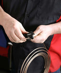 Close-up of a person using a mini tubing cutter from the Heavy Duty Double Flaring Tool Set With Extra Adapters For Copper Aluminum Soft Steel Brake Lines And Brass Tubing Comes With Mini Tubing Cutter And Case Quarter Inch Five Sixteenths Inch Half Inch Three Sixteenths Inch And Three Eighths Inch Adapters.