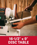 Heavy Duty 6 By 48 Inch Belt And 12 Inch Disc Sander With Closed Stand One Point Five Horsepower Dual Voltage showing 16-1/2" x 9" disc table in use.