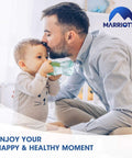 Father holding baby with bottle, Marriotto logo, enjoy your happy and healthy moment text.