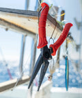 8.5 Inch Stainless Steel Pliers With Non Slip Handle, Spring Loaded, Crimp Tool, Side Cutters, Anvil Cutters, Lanyard Hole And Sheath, TiN Coated For Extra Durability And Rust Resistance hanging on boat