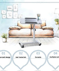 Smooth Operator Height Adjusting Overbed Table Rolling Desktop Stand Up Computer Workstation Multi Purpose Serving Tray on wheels next to a couch.