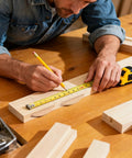 Bearded craftsman measuring wood with tape, preparing Beechwood Joiner Biscuits Set 150 Pieces No 0 No 10 No 20 for precise joints