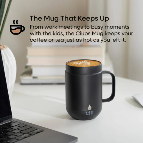 Self Heating Coffee Mug With Rechargeable Battery And Digital Temperature Control Keeps Your Drinks Piping Hot All Day Long Sleek Led Display Makes Temp Swaps A Breeze While The Roomy 16 Oz Black Body Delivers Total Upgrade Vibes For Any Desk Setup on a table next to a laptop.