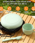 Green all-in-one 6-piece camping mess kit with cup, plate, bowl, utensils, and carry bag on table for travel and outdoor adventures.