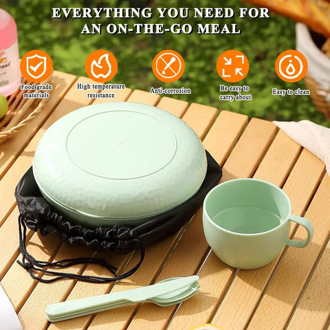 Green all-in-one 6-piece camping mess kit with cup, plate, bowl, utensils, and carry bag on table for travel and outdoor adventures.