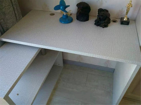 Desktop covered with Textured Fabric Wallpaper Gray Faux Grasscloth Peel And Stick Waterproof Self Adhesive Roll For Countertops.