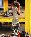 8 Pack 3/8 Inch Twin Clevis Link Zinc Plated G70 Forged Chain Repair Links for truck and trailer tie downs, shown in industrial setting.