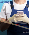 GLOVEWORKS ivory latex disposable gloves; large size, industrial-grade, worn while holding a smartphone.