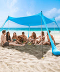 Beach Tent Sun Shelter 10x10ft Pop Up Canopy With UPF50 Plus Shade, Sandbags, Windproof Poles on beach with group of people underneath