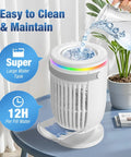 4 In 1 Personal Evaporative Air Cooler With 1200ml Water Tank being filled with water, on a desk with plants and books.