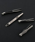 Alloy Pocket Tweezers For Camping And Hiking Gear on textured black surface, different designs shown for outdoor travel use.